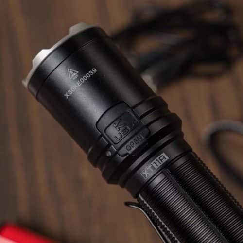 Klarus XT11R Camping Beam Power Klarus XT11R 1300LM flashlight in camping setup, illuminating trails in Kenya for nighttime adventures.