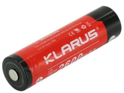 Klarus 18650 battery powering LED flashlight for nighttime hikes, 2600mAh capacity ensures long runtime in outdoor adventures.