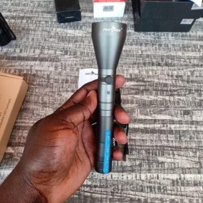 PEETPEN L40 flashlight illuminating campsite with 900 lumens for nighttime camping adventures.