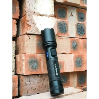 Compact Klarus A1 flashlight illuminating a campsite in Nairobi, Kenya, with 1100 lumens for nighttime camping.