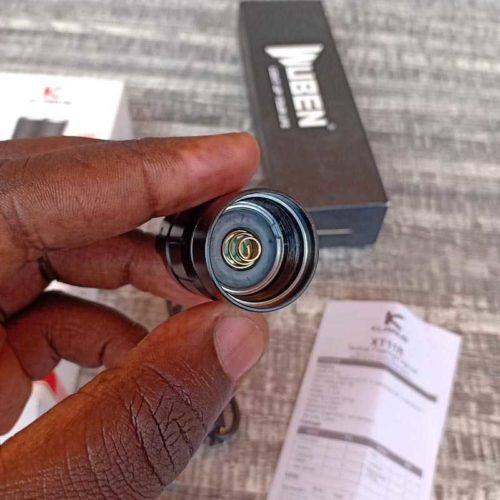 Klarus XT11R Camping Torch 1300LM Beam Klarus XT11R 1300LM flashlight in hand for camping illumination, perfect for Kenya's night trails with 300m beam distance.