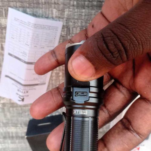 Klarus XT11R for Night Camping Illumination Klarus XT11R 1300LM flashlight illuminating a campsite at night for secure outdoor adventures.