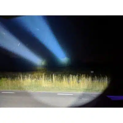 Convoy L21A flashlight beaming 2300 lumens for nighttime camping adventures.