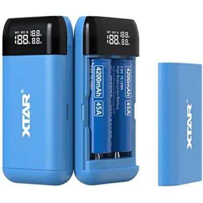 XTAR PB2S power bank charging 21700 battery during outdoor hiking in Kenya for reliable adventure power.