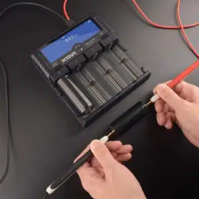 Xtar VP4 Plus smart charger with four bays charging Li-ion batteries at 2.0A, ideal for photographers on outdoor shoots.