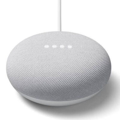 Compact Google Nest Mini smart speaker in living room, perfect for voice-activated music streaming and daily queries.