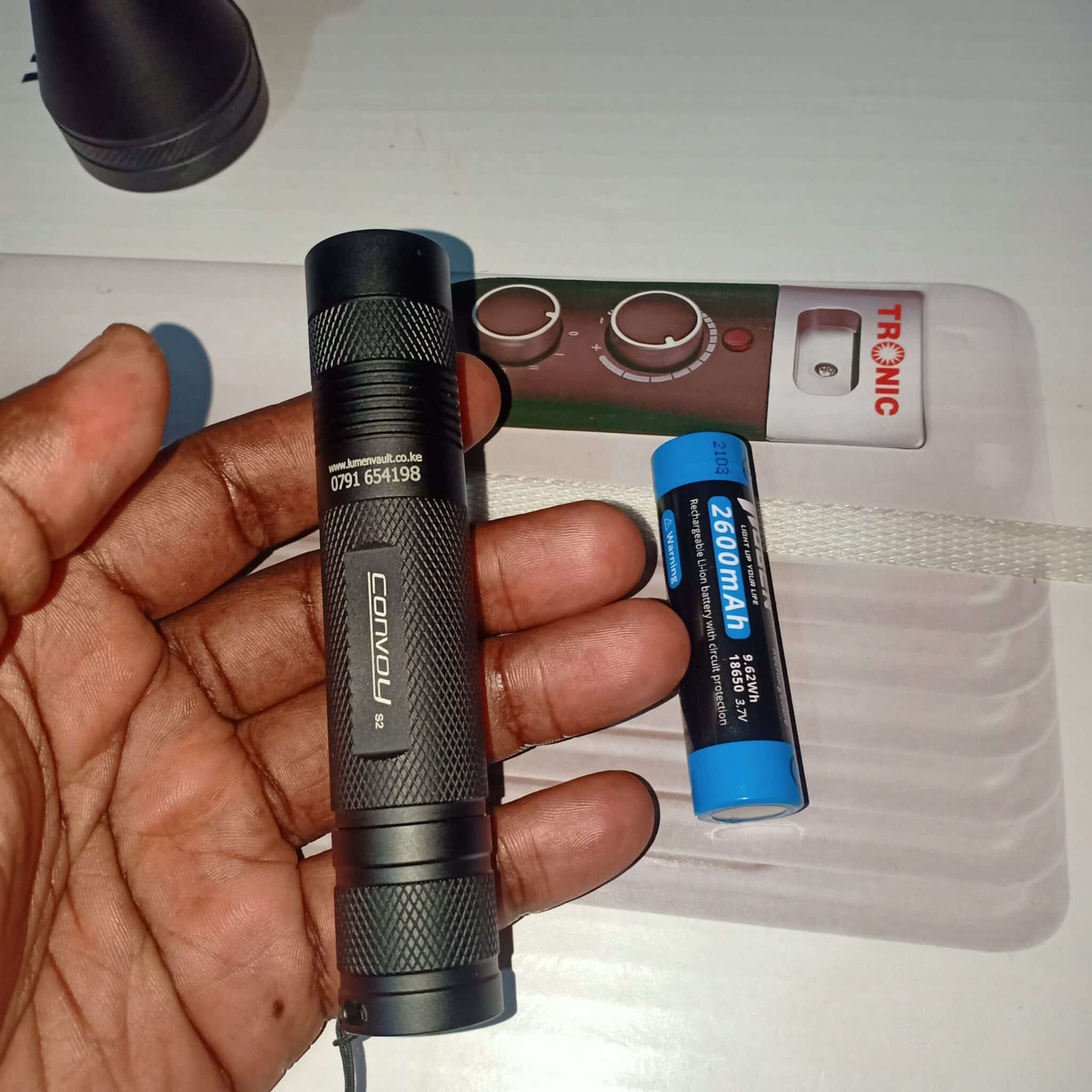 Convoy S2+ 365nm UV flashlight detecting pet urine stains in a household nursery for easy cleanup.