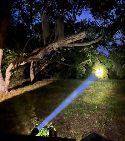 Convoy Z1 flashlight lighting up a campsite at night, 2000 lumens for secure outdoor adventures in Kenya.